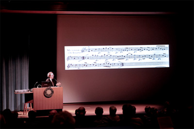 Pre-concert lecture showing close-up of a score